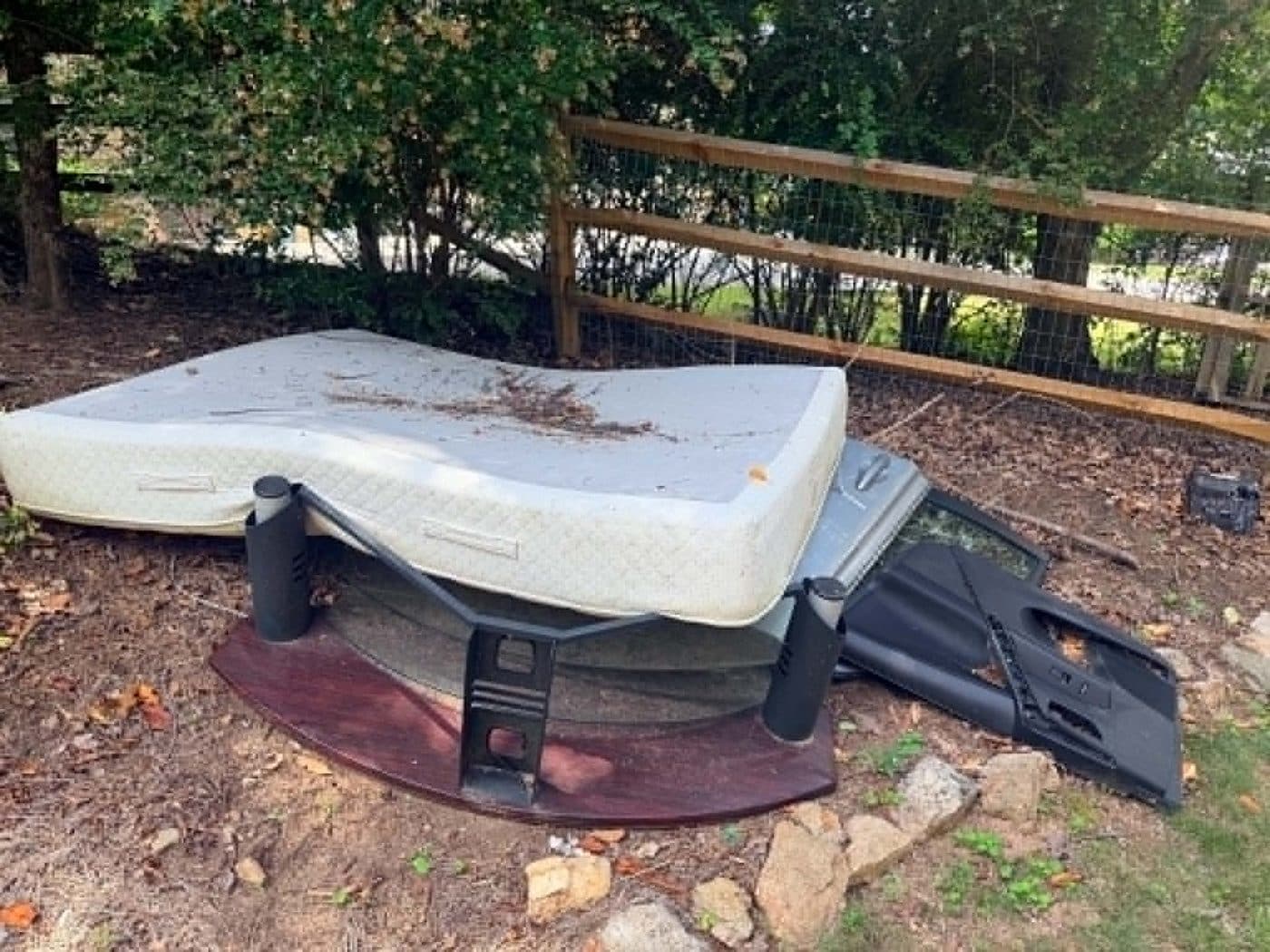 Mattress and mixed debris pile ready for junk hauling near Cumming