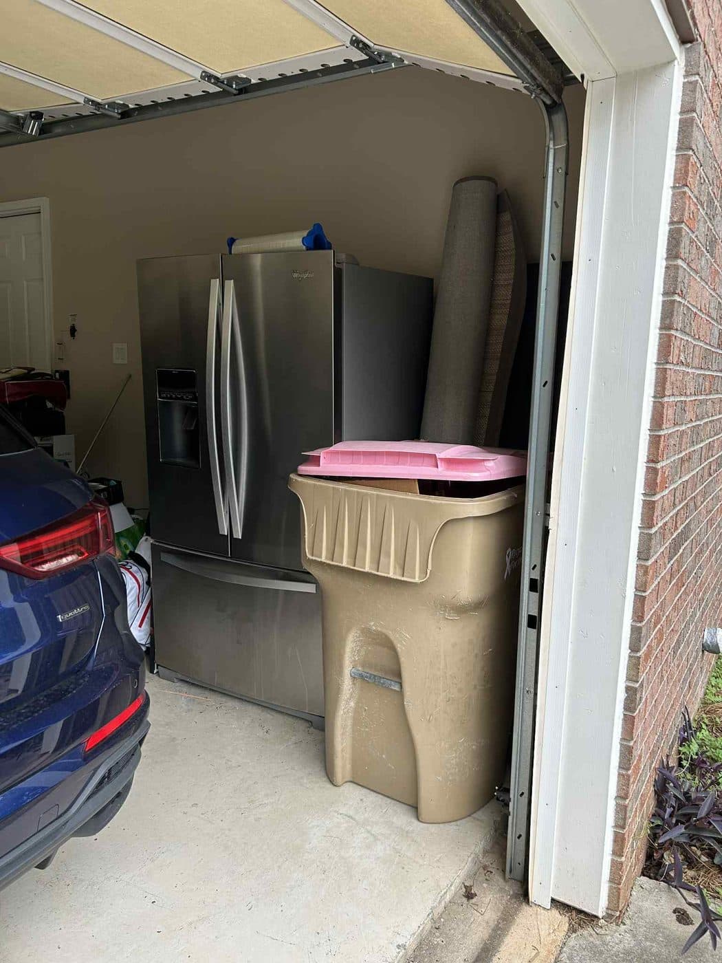 Garage fridge and cleanout items ready for junk removal in Forsyth County